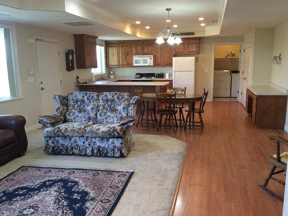 Living room opening up to dining room, kitchen and laundry room. The pantry is on the right next to the desk.