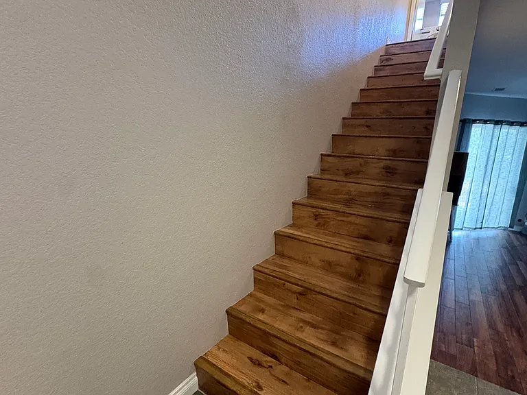 Wood Staircase leading to second story Dual Master Bedrooms