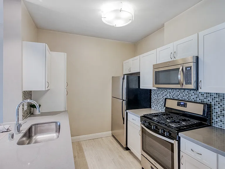 Kitchen with light wood flooring
