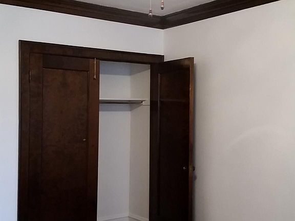 Large living room closet used to house a Murphy bed, and now allows for additional storage.