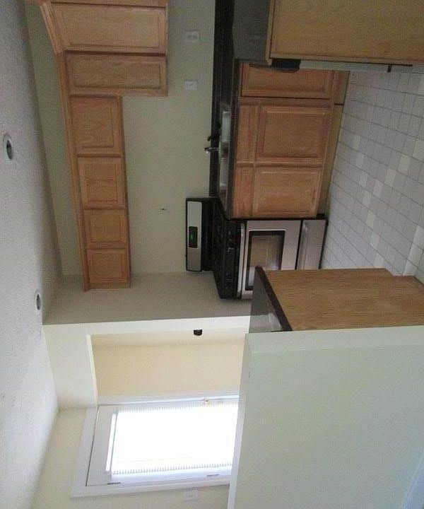 Stack washer dryer in open area to left of stove (not pictured)