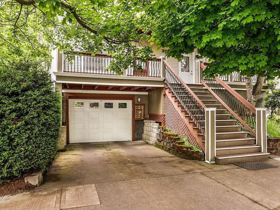 Front building view of common drive-through way, leading to separate private garage. Front stairs lead up to front door, APT A is door on the left.