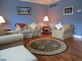 Living room - beautiful real hardwood flooring an crown molding.