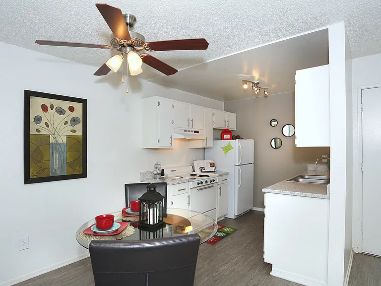 Dining room set with kitchen in the background