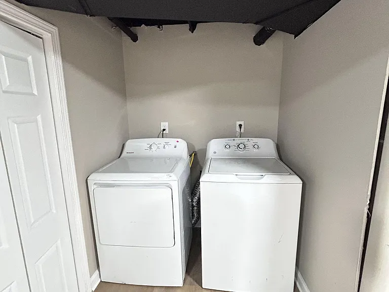 Dedicated laundry nook with side-by-side washer and dryer, offering convenient in-home laundry and easy access.