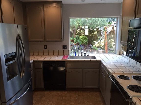 Kitchen with view of parklike backyard