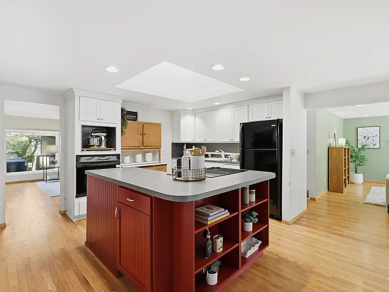 Kitchen with wall oven, cooktop island, and generous counter space