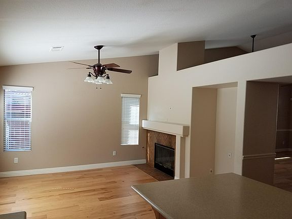 Family Room with wood floors, fireplace and ceil fan.