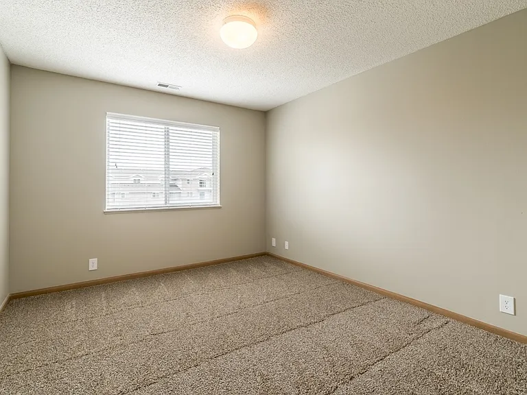 Retreat to your quiet, comfortable bedroom with soft carpeting, natural light, and plenty of space to make it your own.
