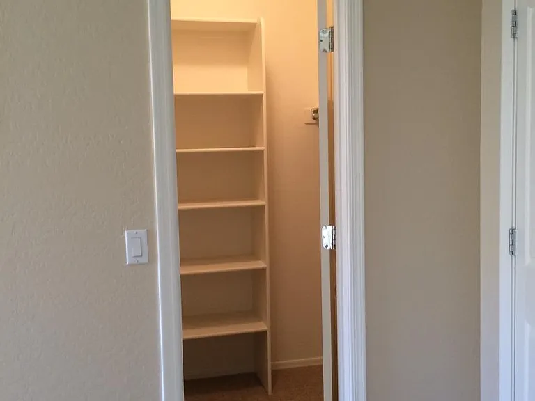 Primary bedroom walk-in closet