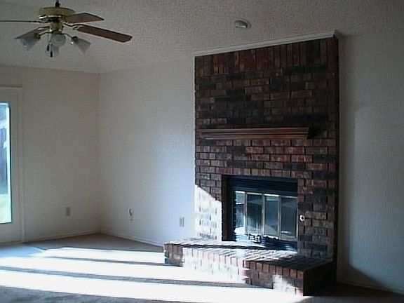 Living area with brick, wood burning fireplace!