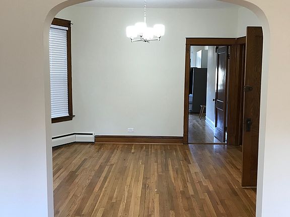 View from living room to dining room and kitchen beyond