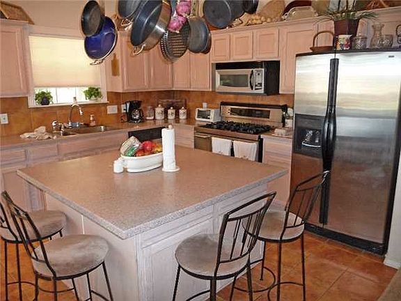 Kitchen : Beautifully updated kitchen has corian-type counter to