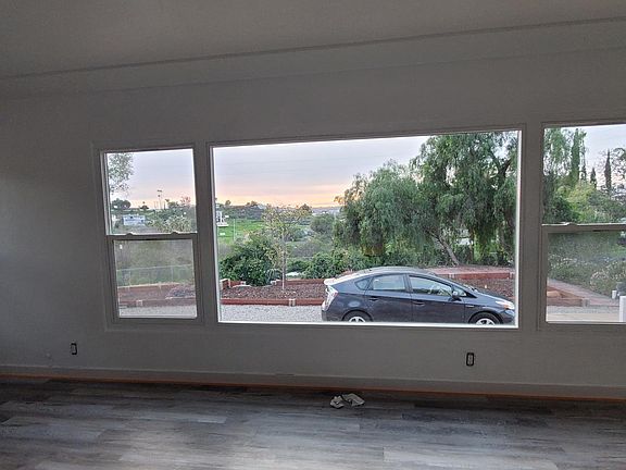 Spacious open living room with a view of the front yard.