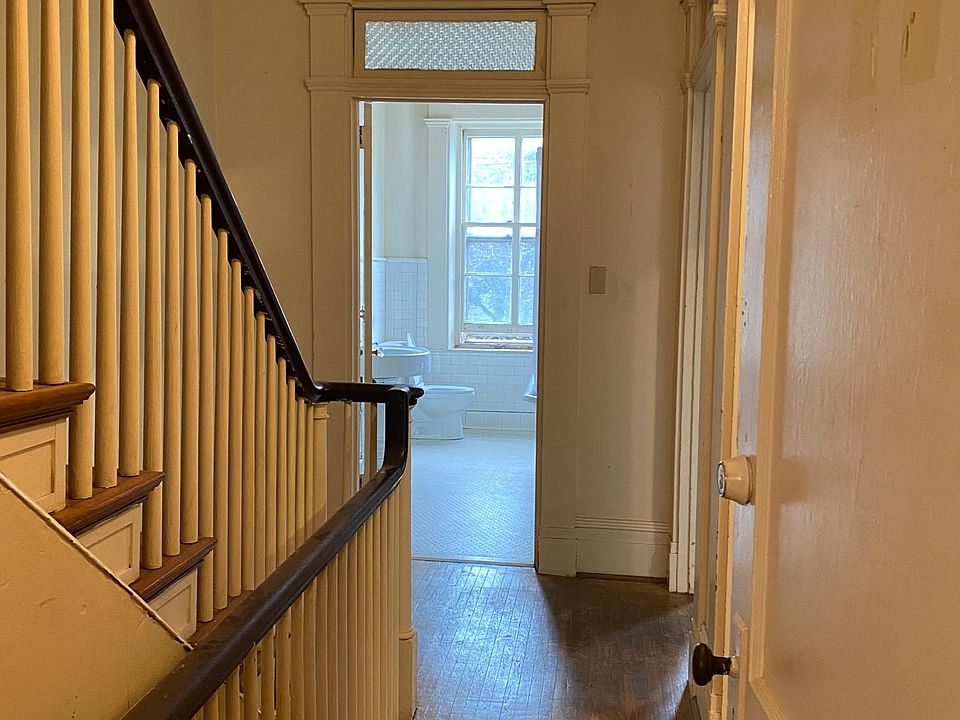 View from front door, staircase leads to unfinished attic space for storage