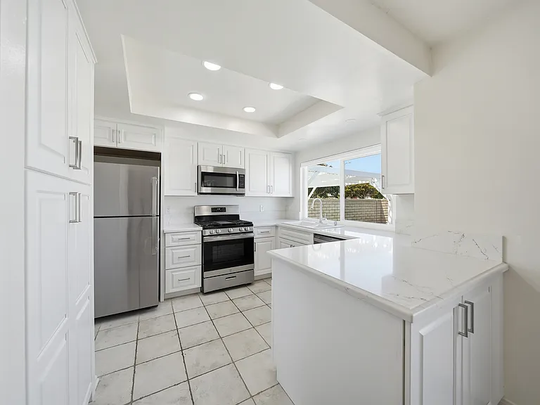 Brand new kitchen remodel, new quartz countertop, pantry, newer stainless steel appliances, recessed lights, and brand new refrigerator.