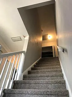 Stairs from front door area to upstairs. Newly carpeted. Lar