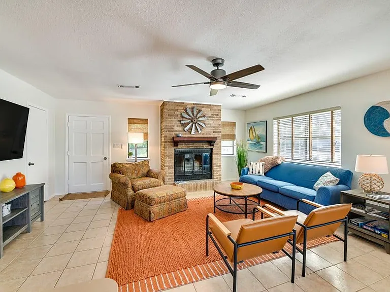 Living room, smart TV and door to small, fenced backyard.