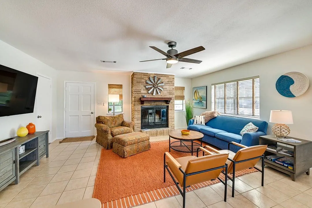 Living room, smart TV and door to small, fenced backyard. - 4210 Chief Ln