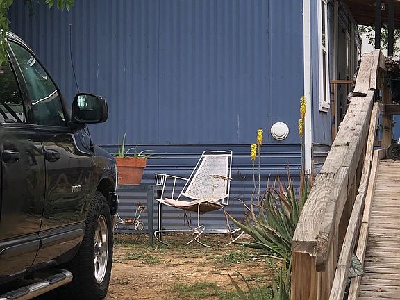Blue Mobile Trailer is one for rent. Entrance is in back of property.