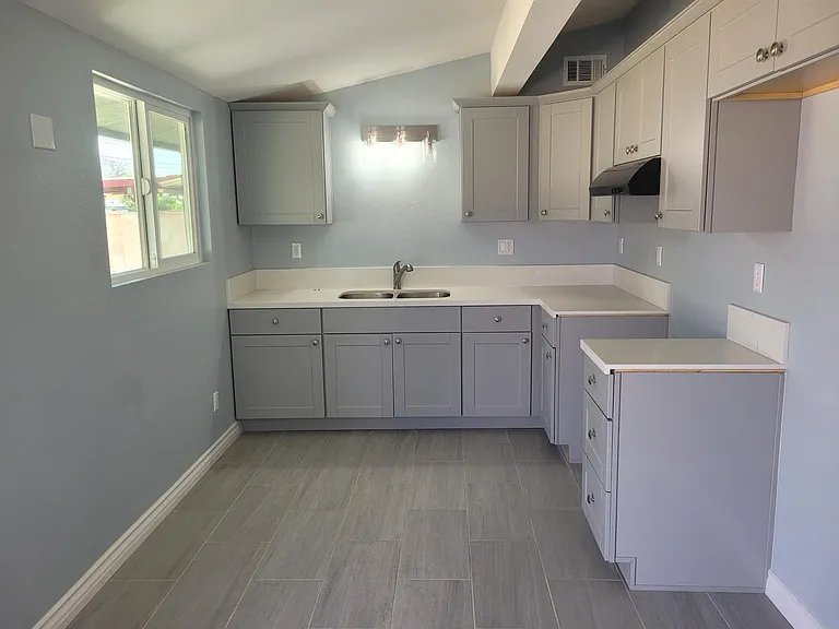 Kitchen has stove and refrigerator