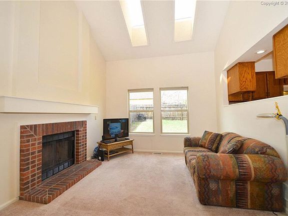 Family room with wood burning fireplace and skylights for extra natural light.
