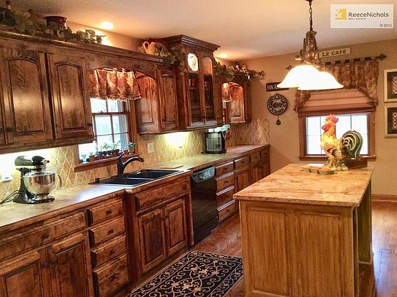A cooks dream kitchen with counter space galore, 27 drawers, granite island & beautiful hardwood floors.