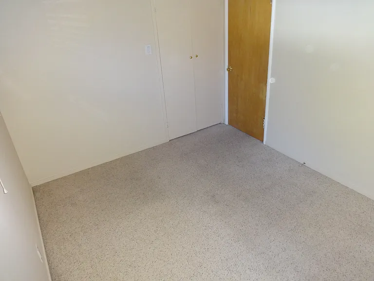 Bedroom with small closet space by the door.