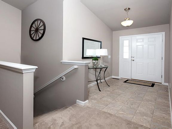 Beautiful entry, and open staircase to lower level.