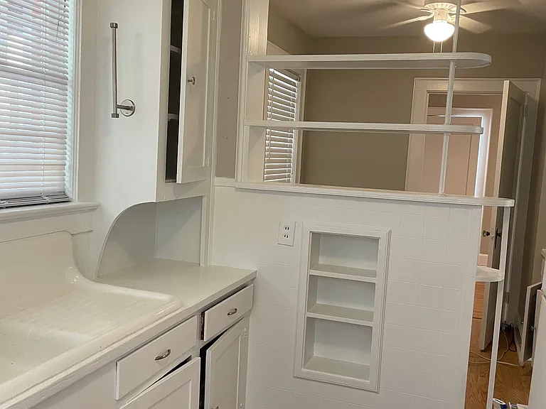 Kitchen looking toward breakfast nook showing original 1950s art deco stylings