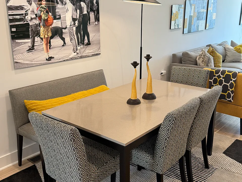 Dining room with marble dining table, bench and four chairs.