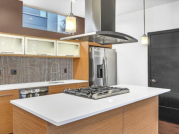 Kitchen with gas range and stainless appliances 