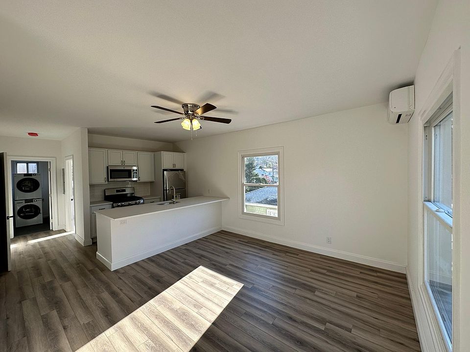 Large living room with open kitchen and work space. 3 large new Andersen windows and brand new A/C and W/D.