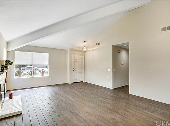 Large windows allowing natural lighting and new custom window coverings & elegant new fixture