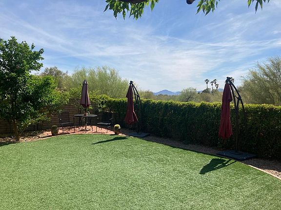 manicured yard with synthetic grass. west facing with amazing sunset views of Gates Pass mountain range.