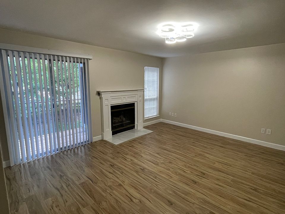 living room with a fireplace and a balcony door