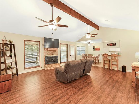 The large living room with wood look tile is the perfect place for the family to gather.