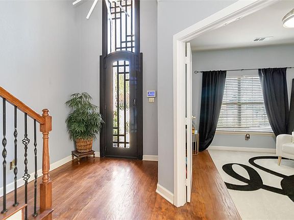 Foyer entrance with wood finished floors and stairway