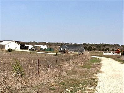 Crushed rock entrance drive leads from gated entry to central de