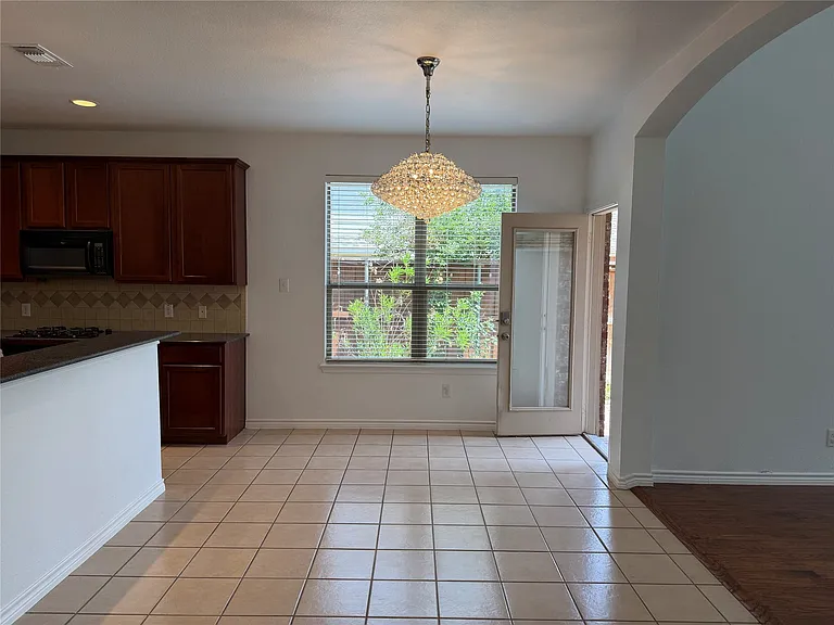 Kitchen dining area with stunning light fixture.