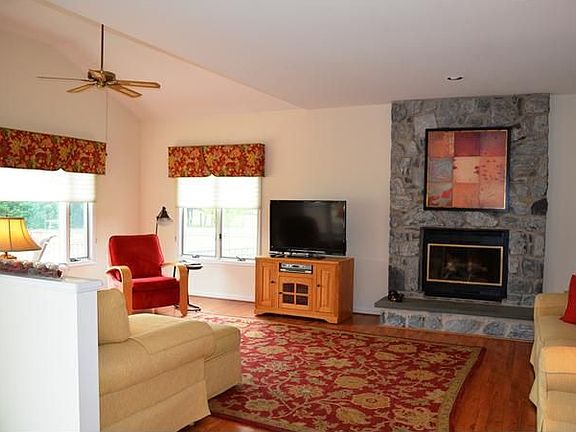 Family Room w Stone Fireplace and Vaulted Ceiling