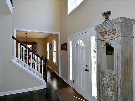 Entry - 2-story with large Palladium window, front door with sidelights, and hand-scraped engineered wide plank flooring.