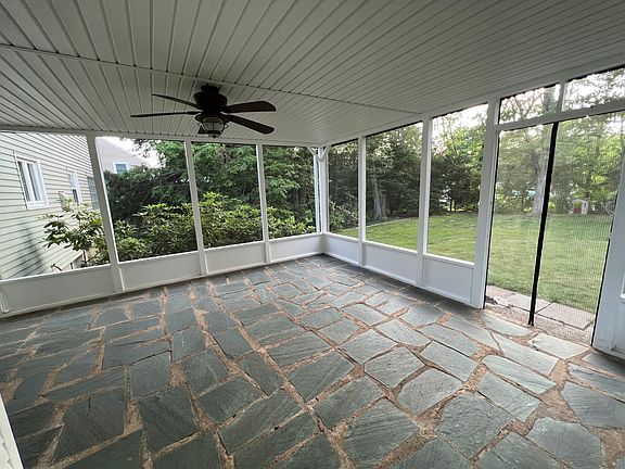 Cool screened in porch with fan, perfect for sipping coffee or entertaining friends.