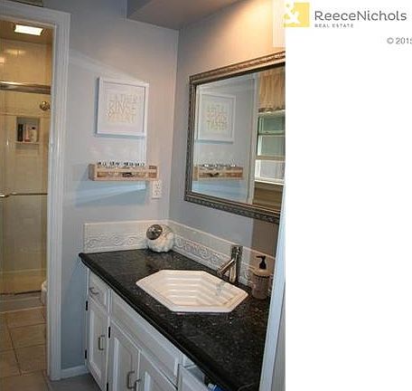 Master bath with tile flooring, newer counter, sink, hardware and faucet.