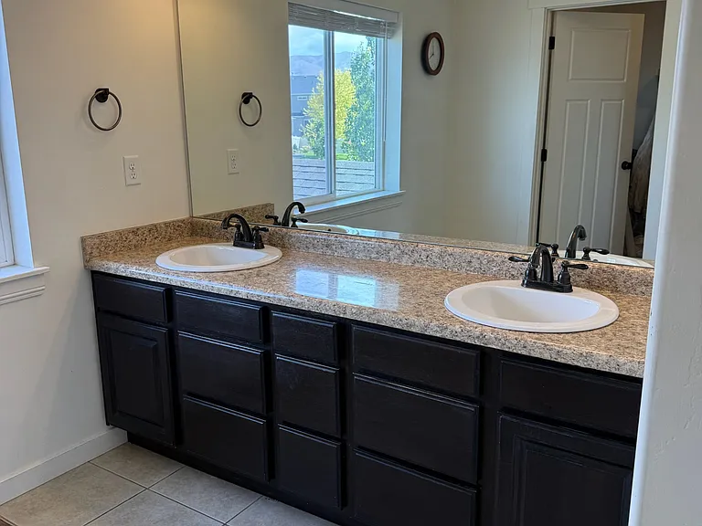Double vanity across from large walk-in closet.