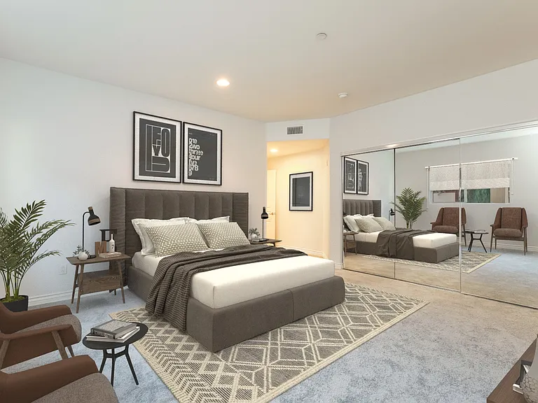 Primary bedroom with wall of mirrored closets virtually staged
