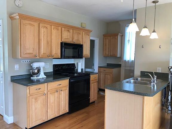 Studio 2nd floor kitchen area - double sink, pendant lights, stove, microwave.