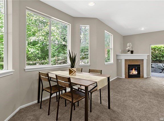Large bay window highlights the dining area with focused can lighting.