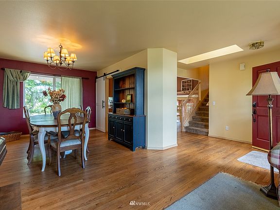 Enter into the hallway/sitting room with open concept to the formal dining room