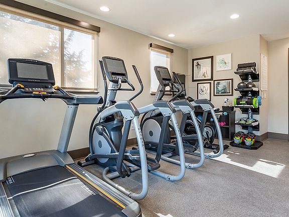 Fitness center with cardio equipment.